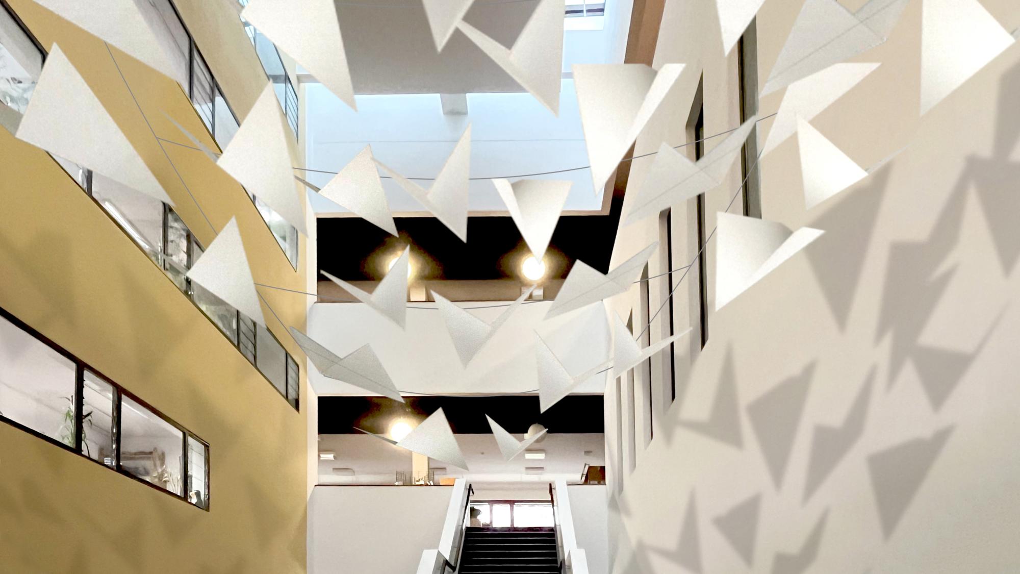 Treppe in der Bibliothek mit darber h?ngenden Girlanden in geometrischen Formen, die einen Schatten an die Wand werfen